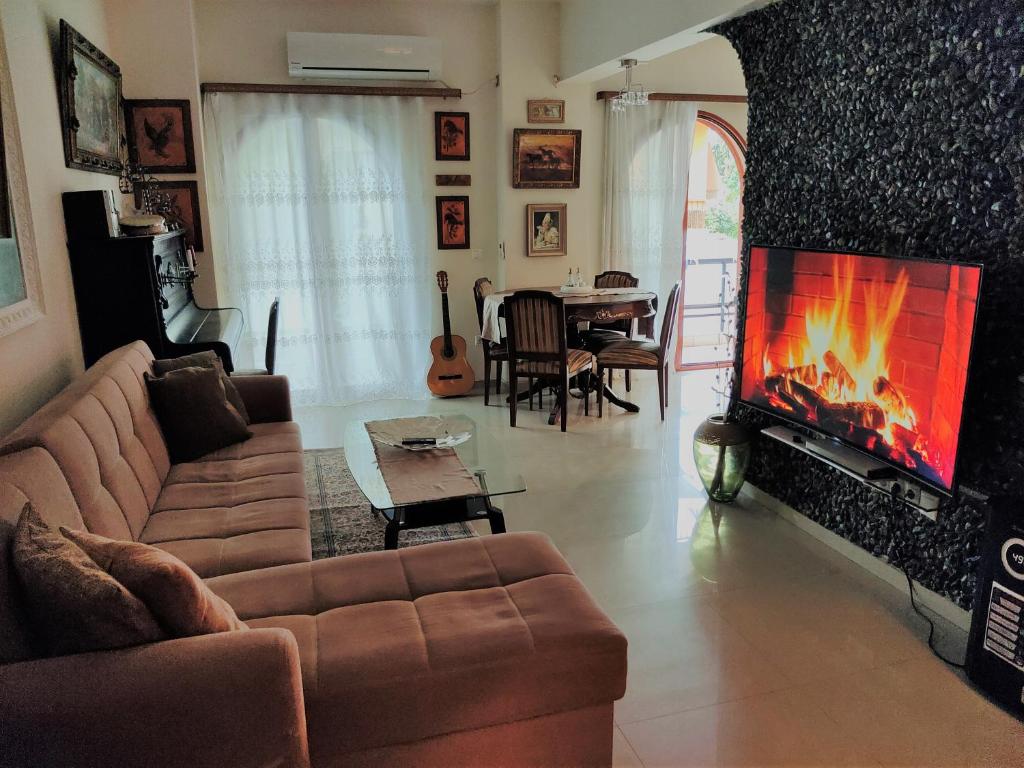 a living room with a couch and a fireplace at Κατερινα in Athens