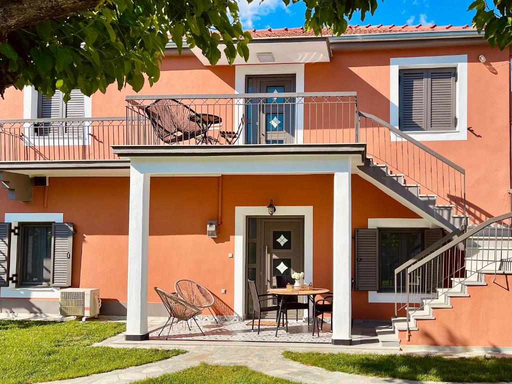a house with chairs and a table in front of it at Casa Delicosta- 2 Flat Country house with garden, 15 min from Trikala in Tríkala