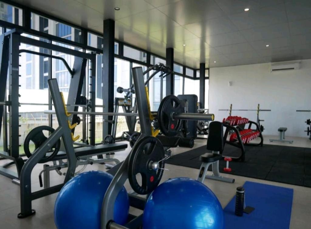 a gym with a lot of equipment in a room at Serene Studio Pollux Batam Center - High Floor Sea View in Batam Center