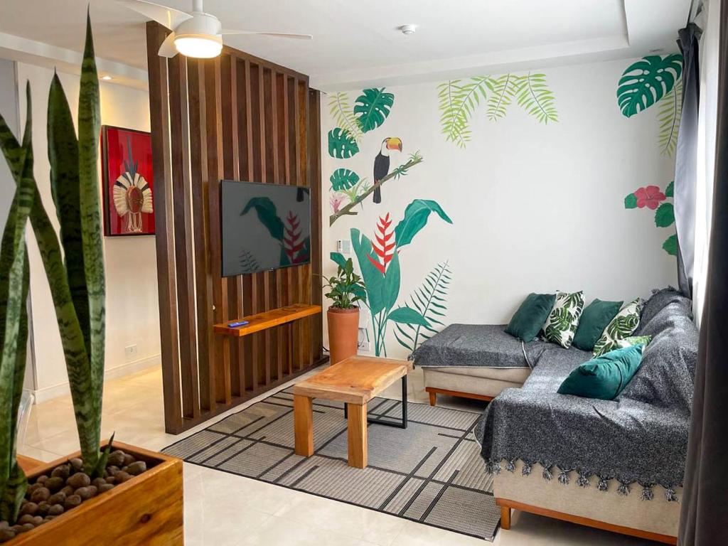 a living room with a couch and a table at Apartamento Aldeia da Praia in Porto Seguro