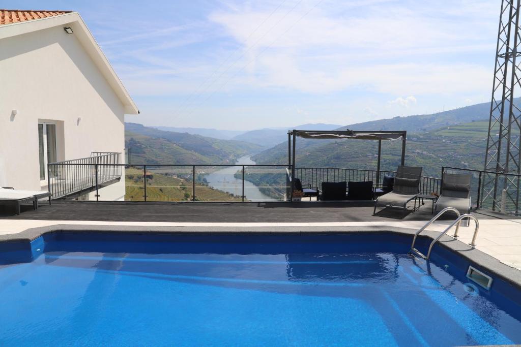a swimming pool with a view from a house at Casa Vale do Douro in Mesão Frio