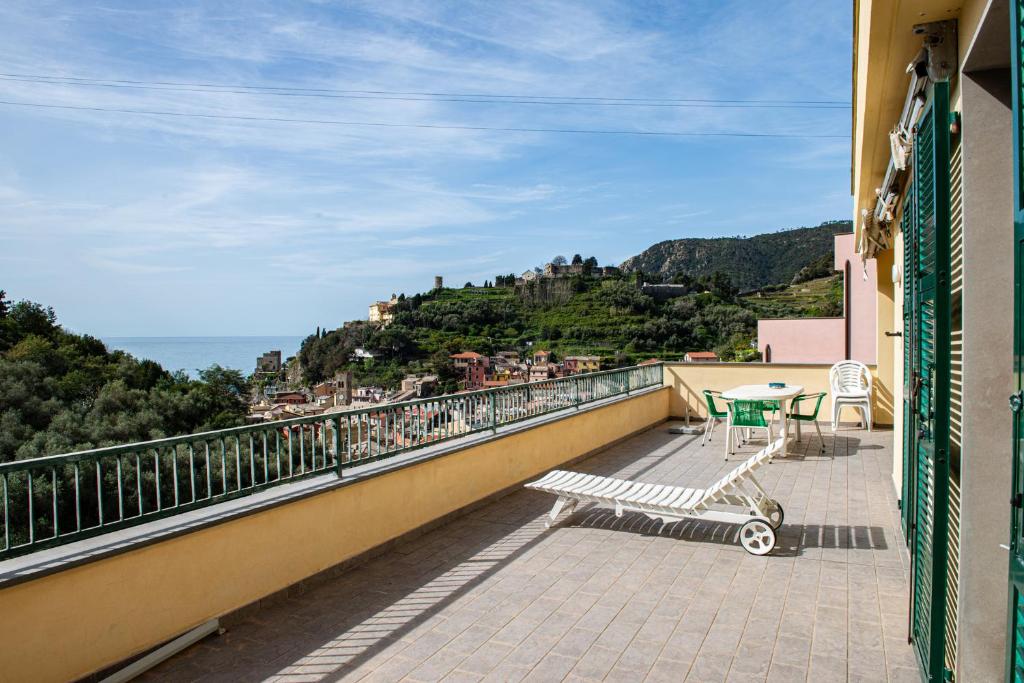 a balcony with a table and chairs on top of a building at Monterosso view apartment 5 Terre in Monterosso al Mare