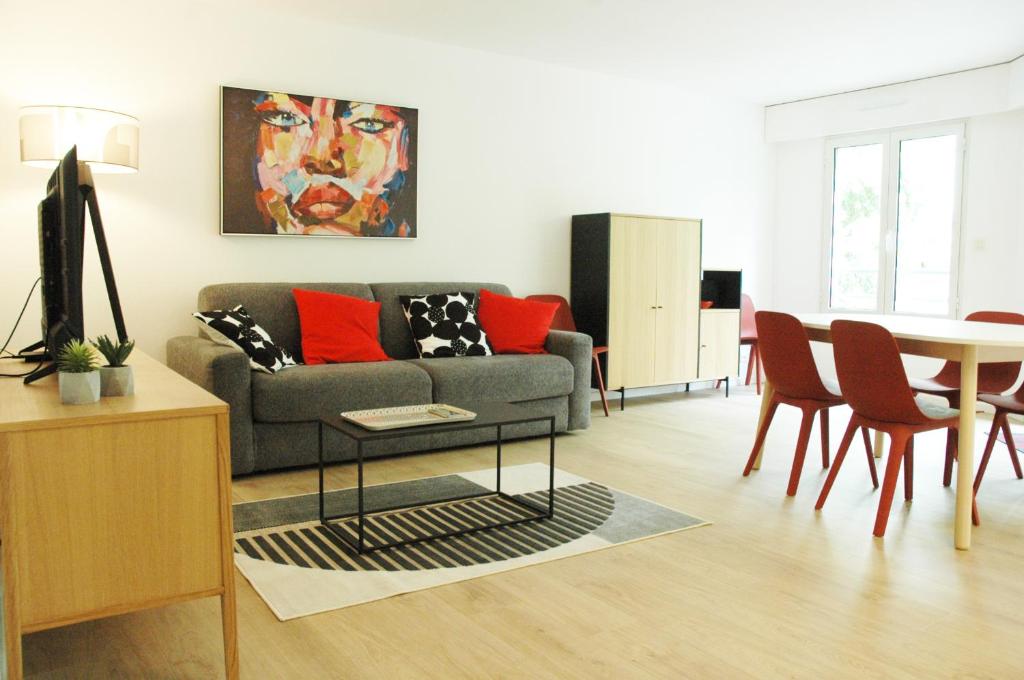 un salon avec un canapé et une table dans l'établissement Vaste et lumineux appartement, à Antibes