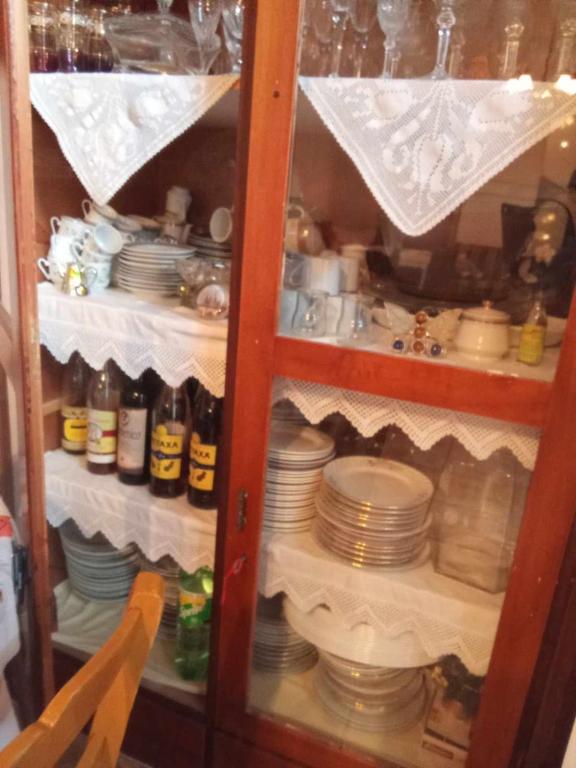 a cabinet full of dishes and plates in a room at house FYNTIKAKH - SKALA in Anopoli Sfakion