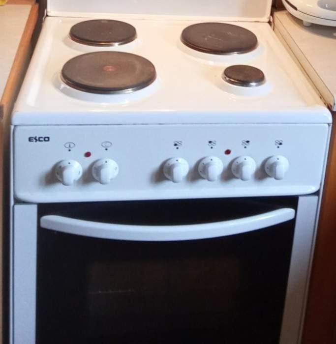 a white stove top oven sitting in a kitchen at house FYNTIKAKH - SKALA in Anopoli Sfakion