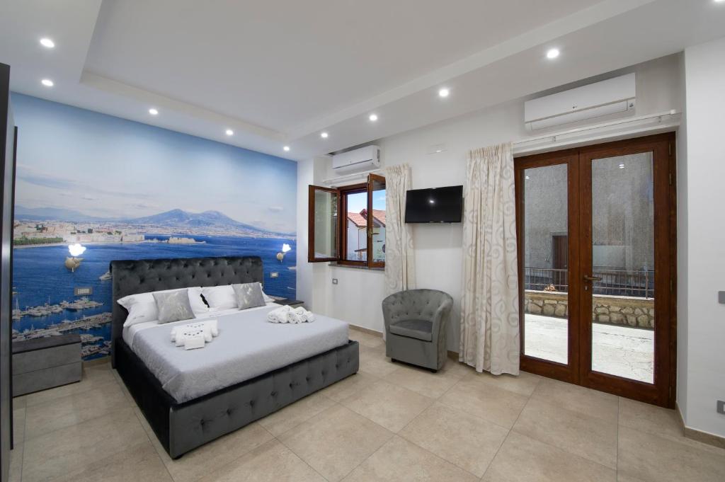 a bedroom with a bed and a painting on the wall at Le 5 Perle in Agerola