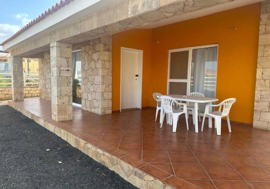 a patio with a table and chairs on a house at Villa Baleia Stella Maris Exclusive in Calheta Do Maio