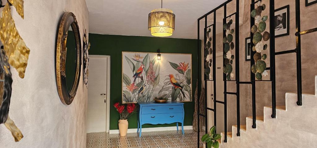a hallway with a blue dresser in a room with plants at Boutique Villa Revelin in Pag