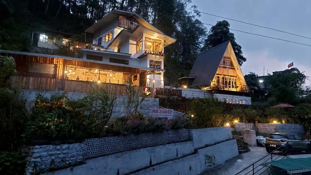 a large house with lights on it at night at Zangmo Lee Baam Rezay gangtok Sikkim in Gangtok