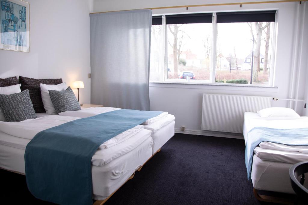 Postel nebo postele na pokoji v ubytování Hotel Strandparken