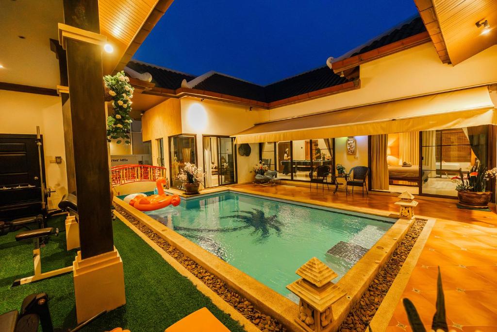 a swimming pool in the middle of a house at November T Pool Villa 2 in Jomtien Beach