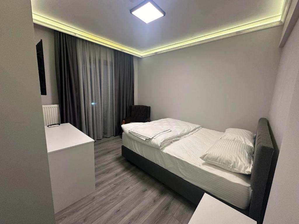 małą sypialnię z łóżkiem w pokoju w obiekcie Aslan Airport Hotel w mieście Arnavutköy