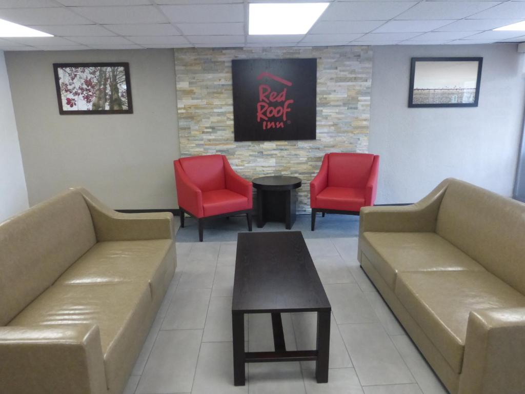 a waiting room with couches and red chairs at Red Roof Inn Stroudsburg in Stroudsburg