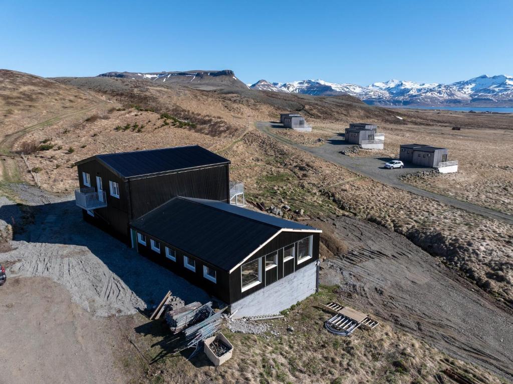 an overhead view of a black and white house on a hill at Dis Cottages in Grundarfjordur
