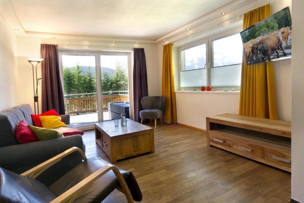 a living room with a couch and a table at Neumond -405- in Ahrn