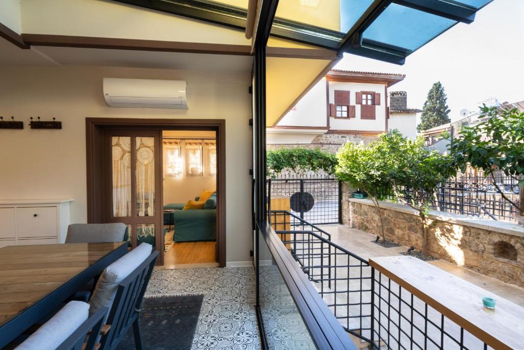 a patio with a table and chairs on a balcony at Cozy Home in Oldtown Kaleici in Antalya