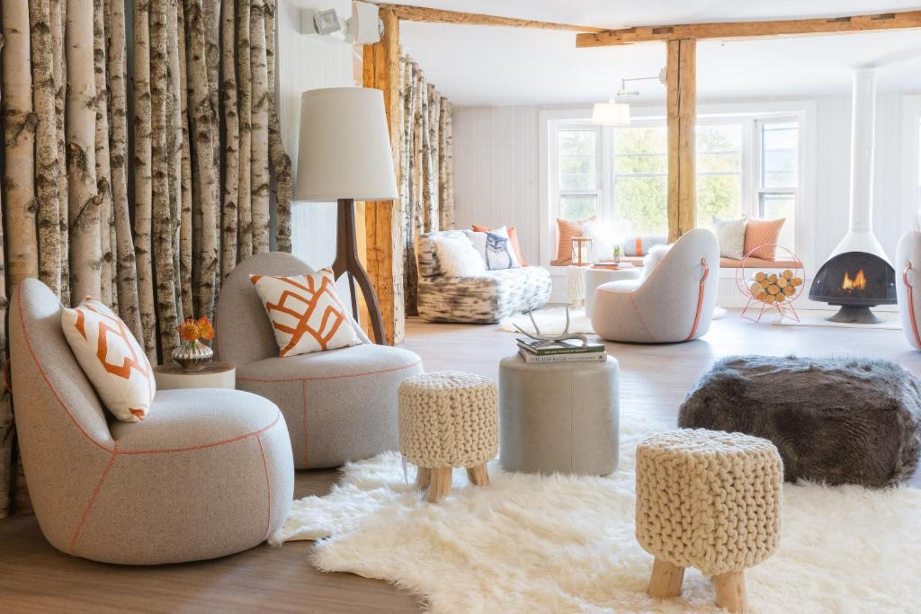 uma sala de estar com muitas cadeiras e mesas em Field Guide Lodge em Stowe