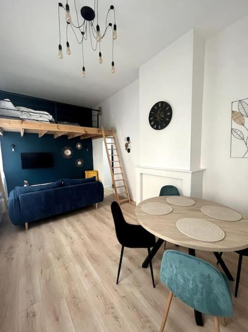 un salon avec une table et des chaises et un lit dans l'établissement chez Corinne, à Bray-Dunes