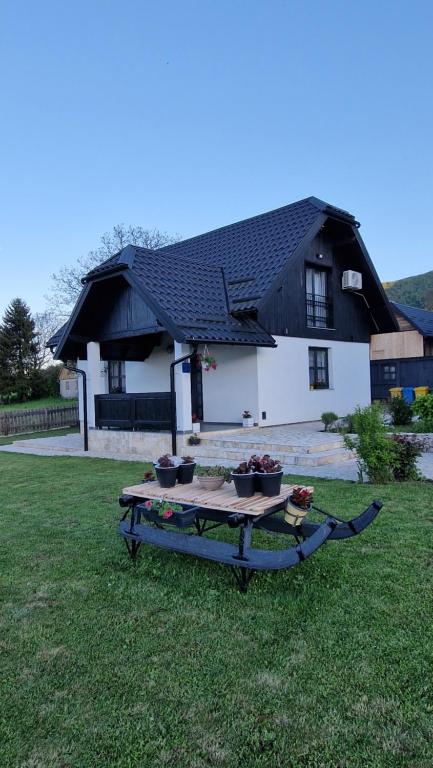 een tafel in het gras voor een huis bij Plitvice Apis in Korenica