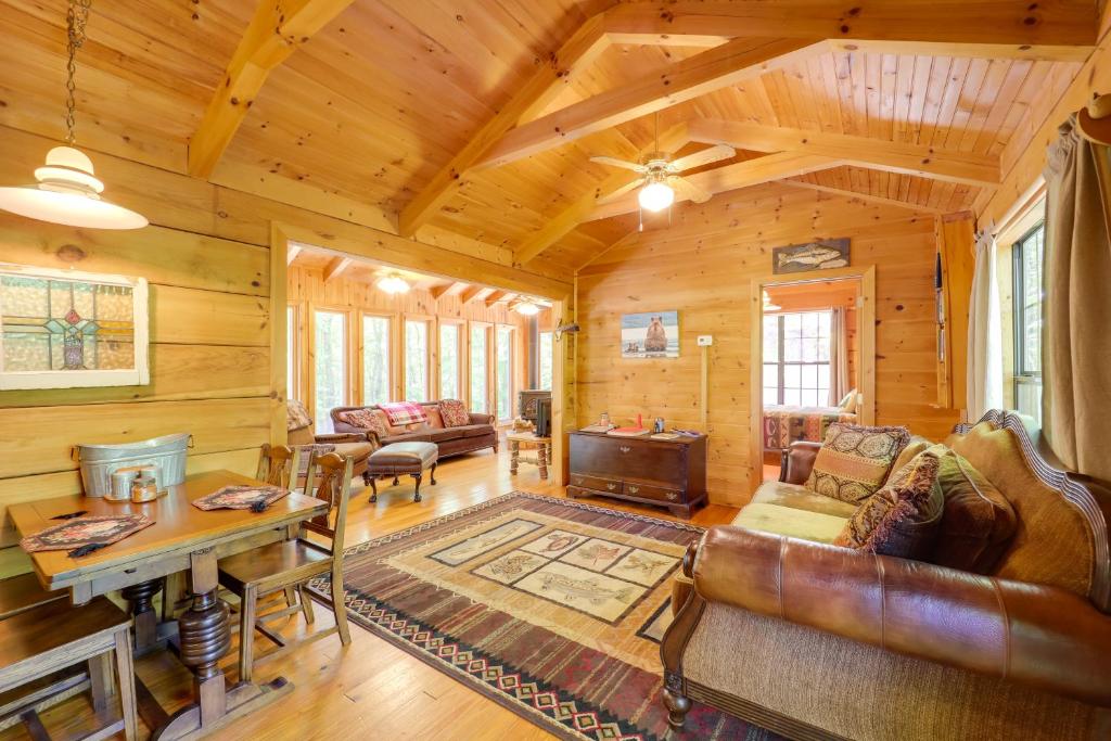 a log cabin living room with a couch and a table at Cataloochee Ski Day Trips! Hot Tub Haven in Marion in Marion
