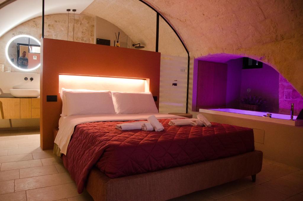 Ένα ή περισσότερα κρεβάτια σε δωμάτιο στο Suite Santa Caterina