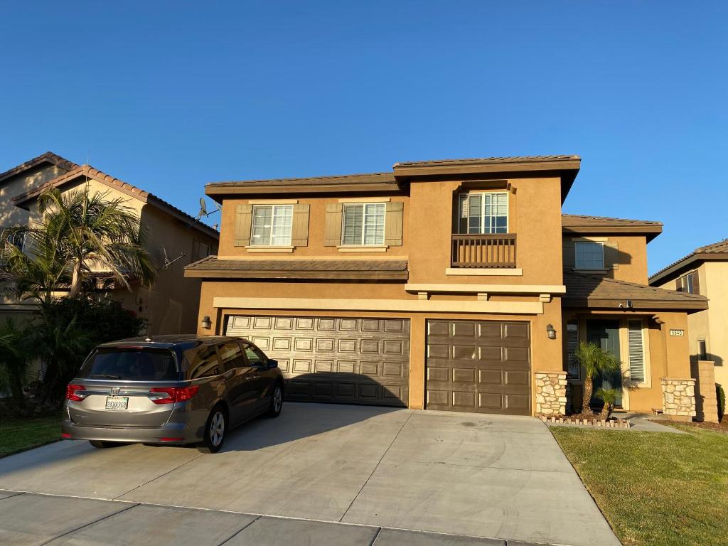 a car parked in a driveway in front of a house at Bella's sweet house 5640 in Eastvale