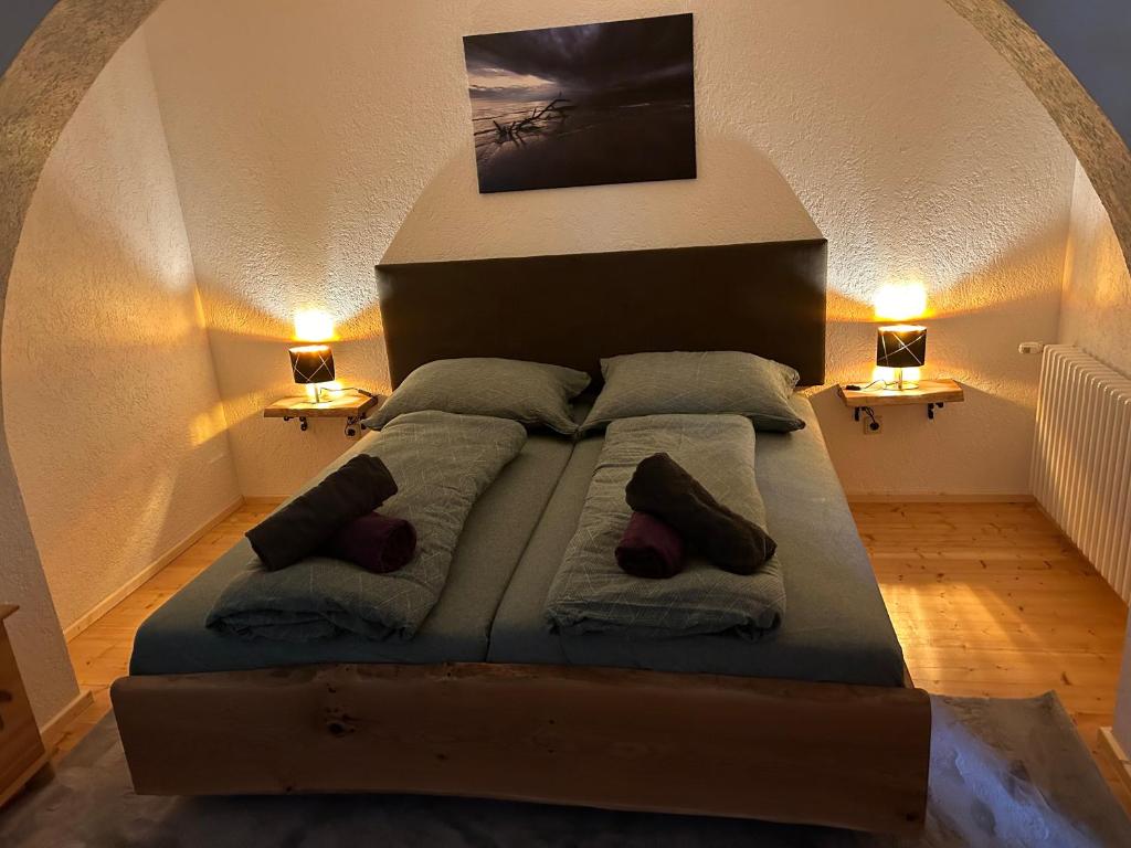 un grande letto in una stanza con due lampade di Ferienwohnung Mariana a Bad Ischl