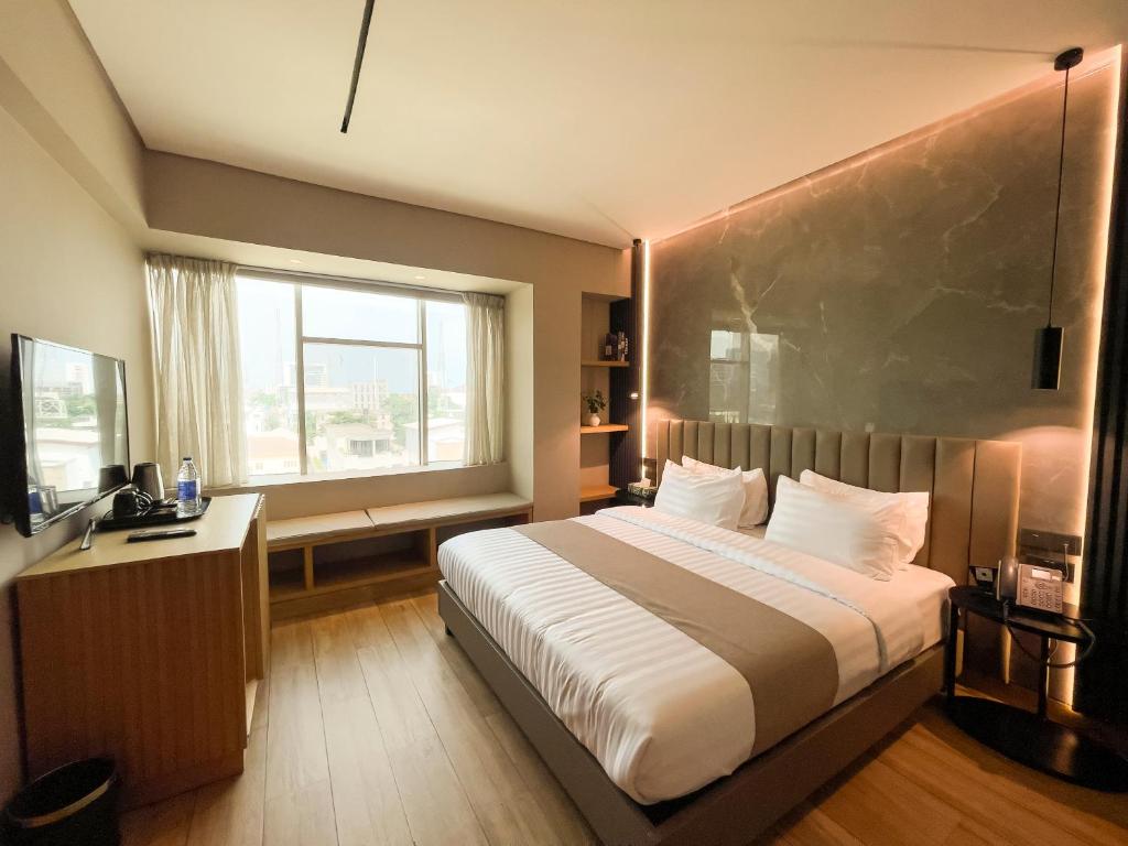 Postel nebo postele na pokoji v ubytování Vertigo Hotel
