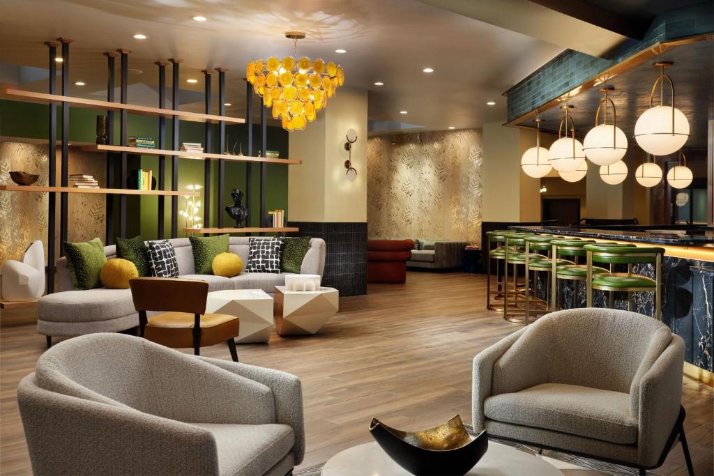 a lobby of a hotel with chairs and a bar at Burton House, Beverly Hills, A Tribute Portfolio Hotel in Los Angeles