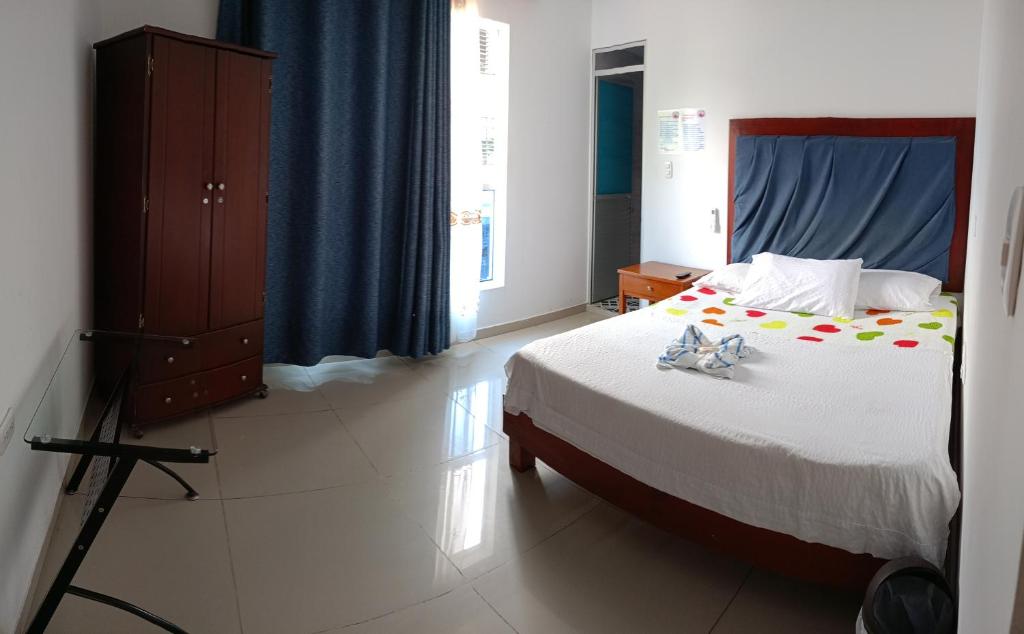 Postel nebo postele na pokoji v ubytování Hotel Bella Orquidea
