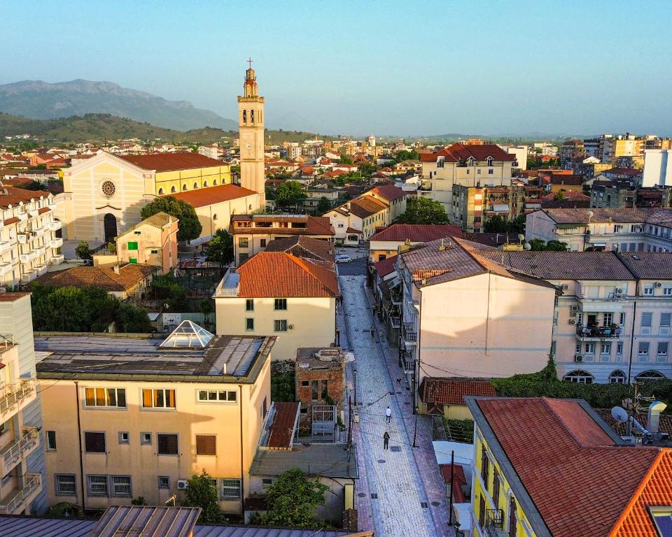 a view of a city with a clock tower at Gjuhadol stay by Marina in Shkodër