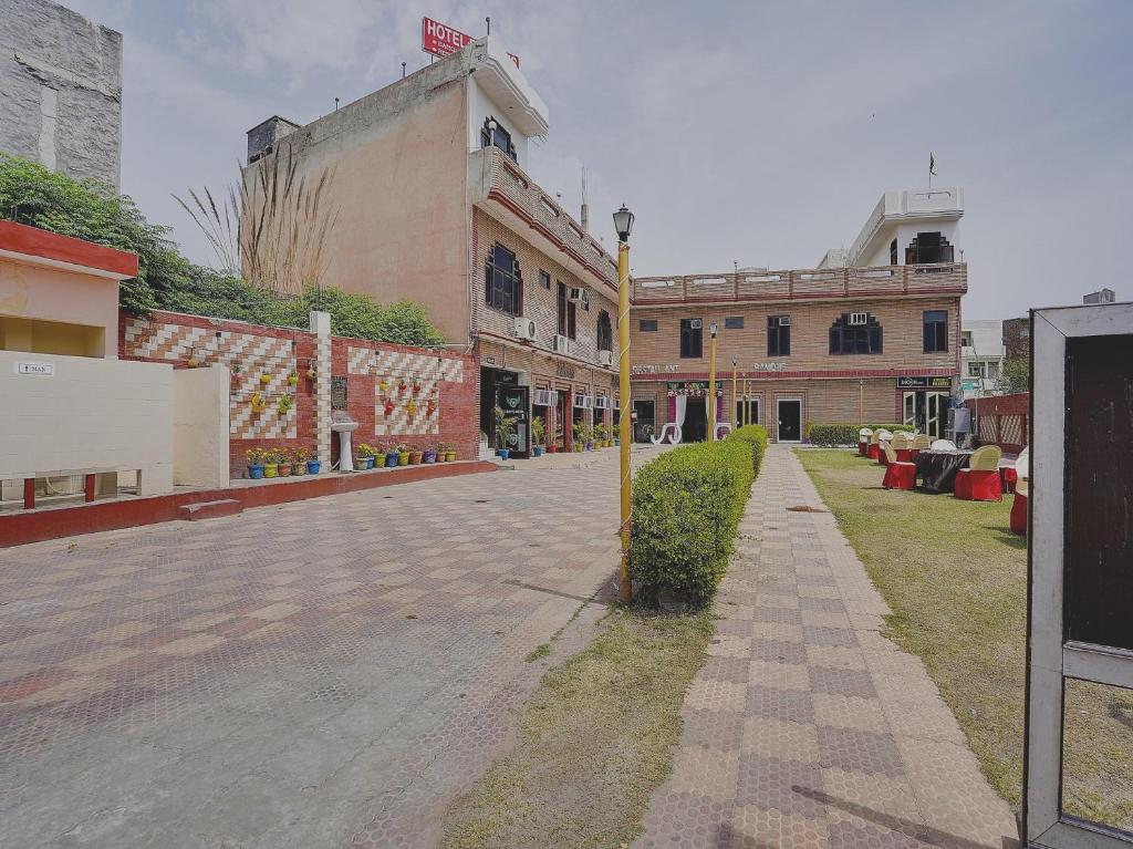 an empty street in a city with buildings at OYO Hotel Fridays in Bathinda