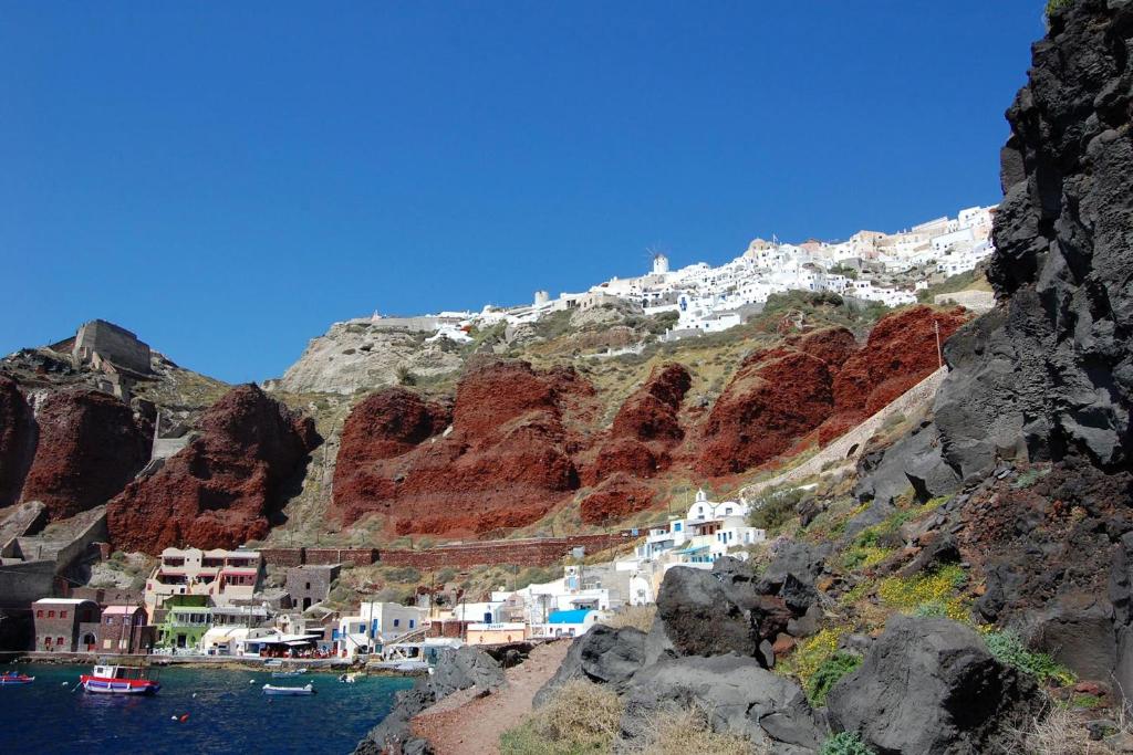 a view of a village on a mountain at Premium Santorini Villa Villa Campbell 1 Bedroom Spectacular Aegean Sea Views Private Outdoor Hot Tub Imerovigli in Imerovigli