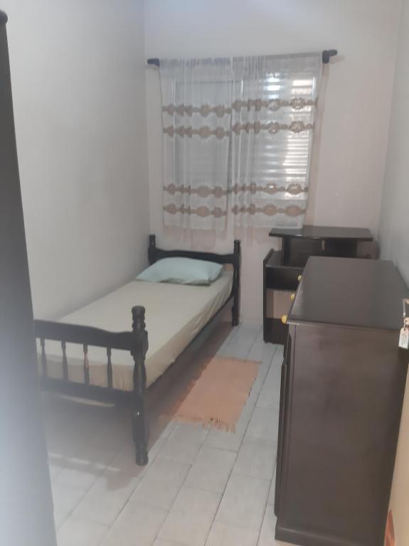 Ένα ή περισσότερα κρεβάτια σε δωμάτιο στο Hospedaria Jaguaré