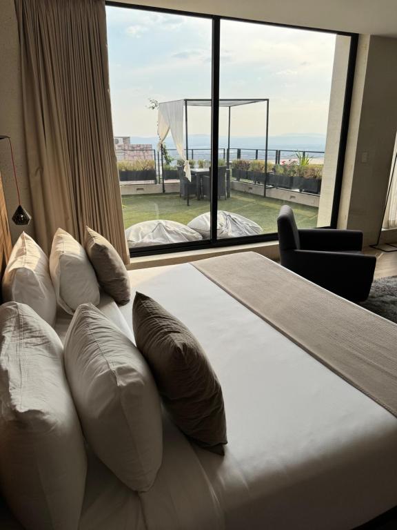 Postel nebo postele na pokoji v ubytování Ilo Rojo Hotel Boutique