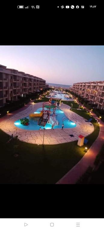 a large pool with a playground in a building at دلتا مارينا in Al Ḩammād