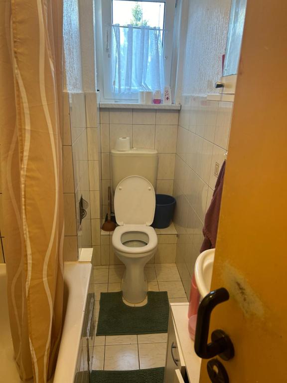 a small bathroom with a toilet and a window at Classic home4u in Essen