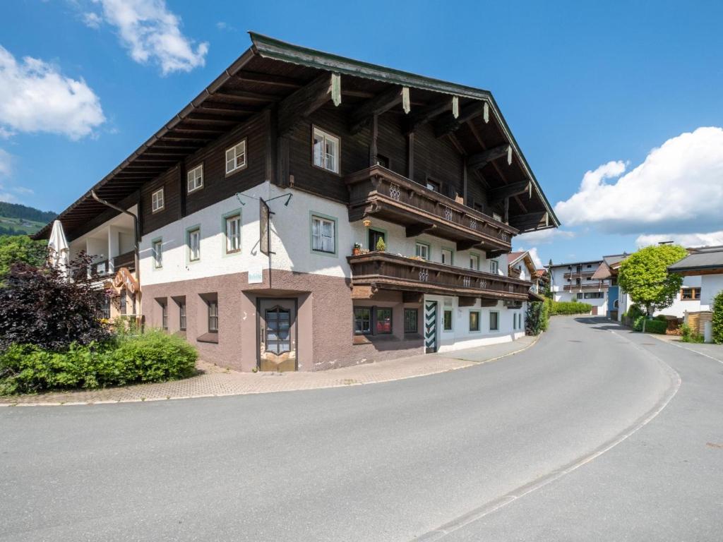 a large wooden house on a road at Gaisbergblick XXL in Kirchberg in Tirol