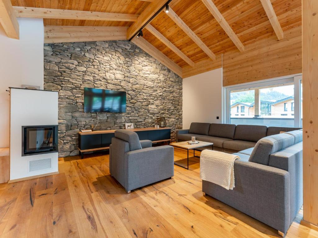 a living room with a couch and a stone wall at Luxury Sankt Lorenzen in Sankt Lorenzen ob Murau