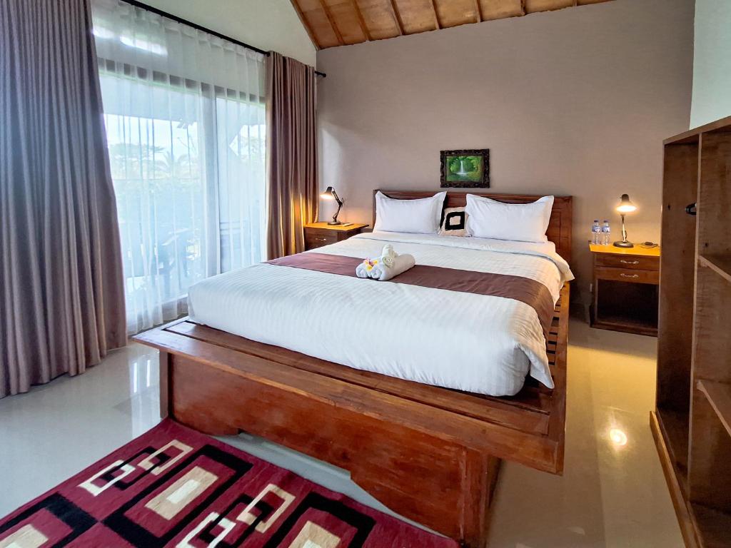 Postel nebo postele na pokoji v ubytování Novia Guest House Lombok-Tetebatu