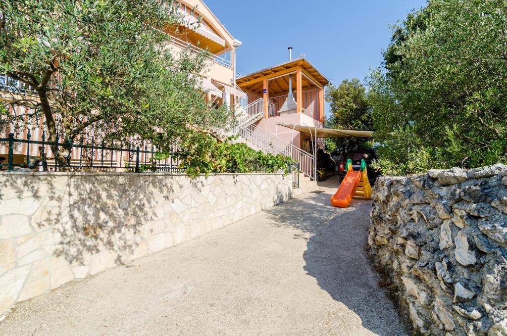 a retaining wall next to a house with an orange cone at Apartments with parking space Banici, Dubrovnik - 23176 in Slano