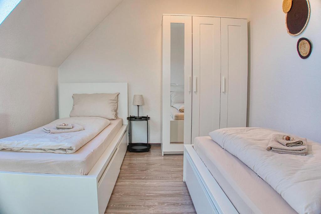 a bedroom with two beds and a mirror at No2 by 21 Apartments in Kaarst