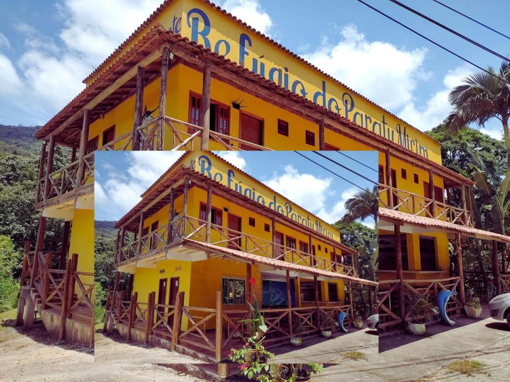 帕拉蒂的住宿－Refugio Do Paraty Mirim，黄色的建筑,上面有标志