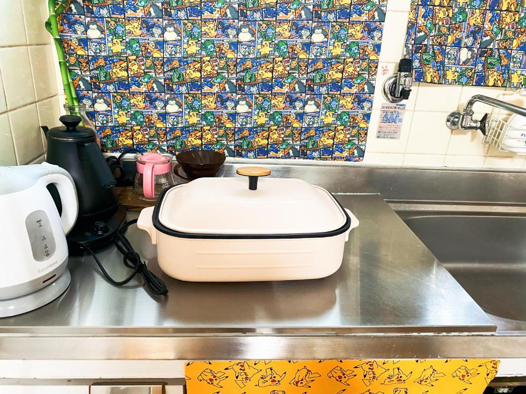 a white toaster sitting on top of a kitchen counter at Pokémon Sleep 宝可梦的家 in Osaka