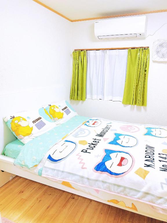 a small bedroom with a bed with a window at Pokémon Sleep 宝可梦的家 in Osaka