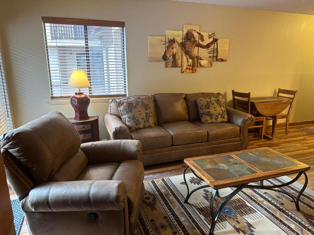 a living room with a couch and a table at Lifts West G8 in Red River