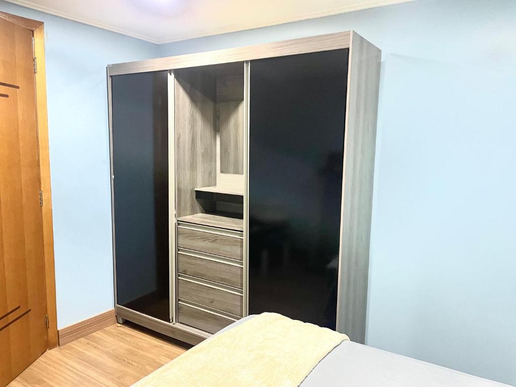 a large black closet with a bed in a room at CASA EM FOZ DO IGUAÇU DESTINO DO MUNDO in Foz do Iguaçu