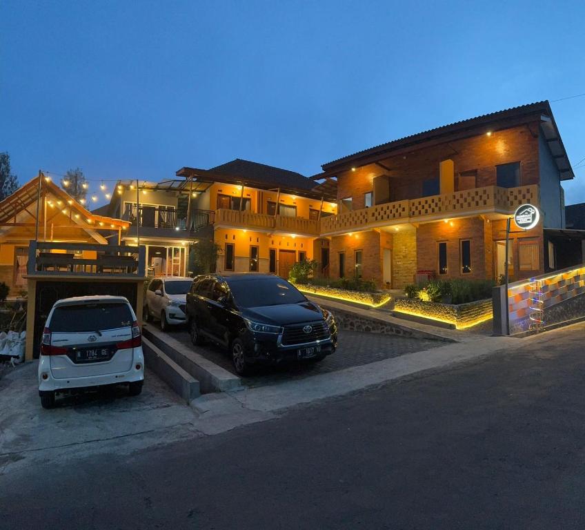 a couple of cars parked in front of a building at Homestay Lereng Bromo in Bromo