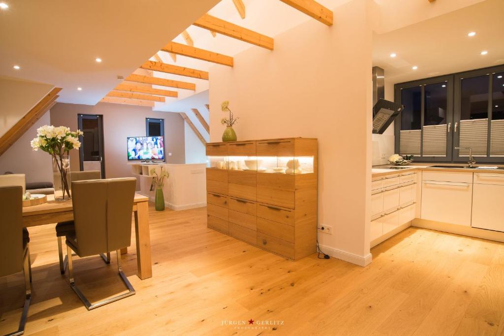 a kitchen with a desk and a dining room at Weidestr 18 Wohnung 2 ( Captains' finest) in Heiligenhafen