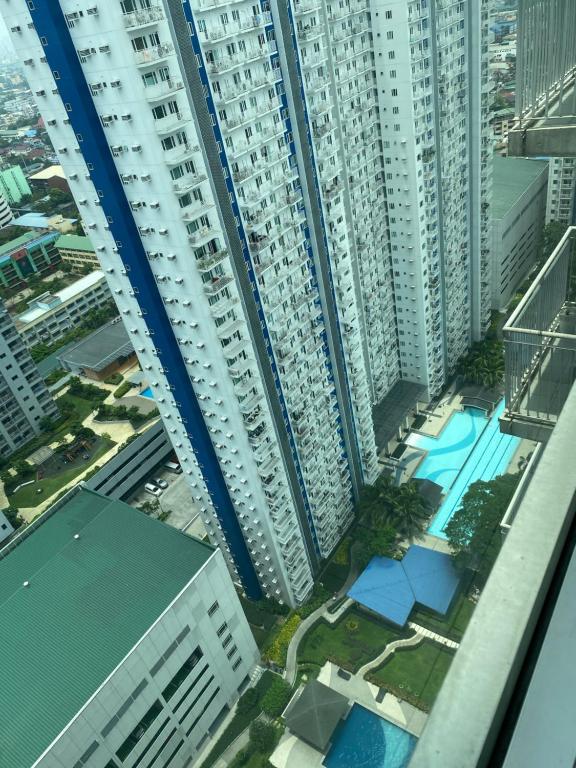 an aerial view of a city with tall buildings at Grass residence tower3 30th Floor in Manila